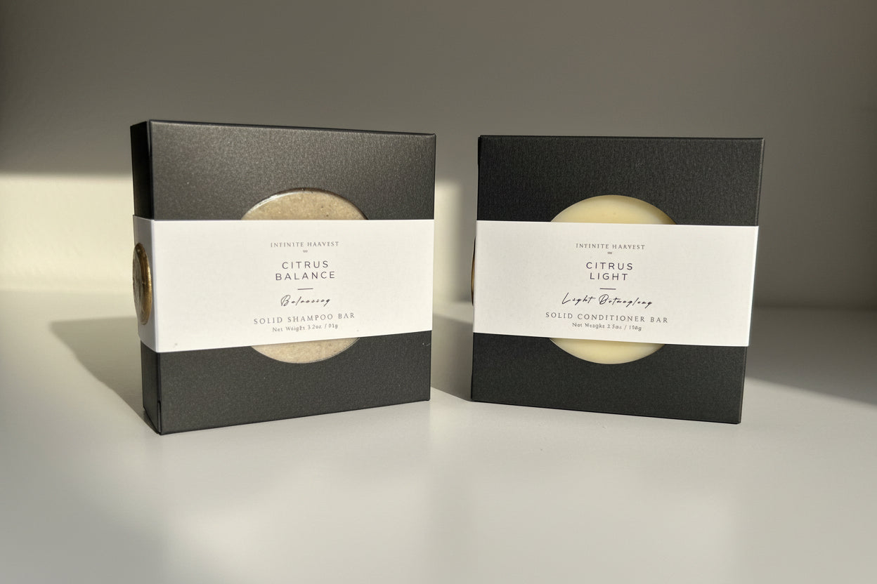 Solid shampoo bar called Citrus Balance on the left and Solid conditioner bar called Citrus Light on the right. 